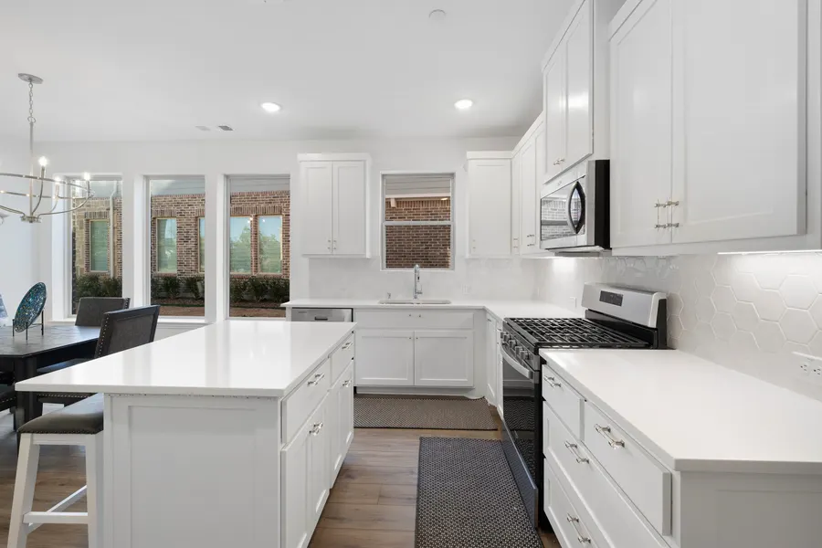 Kitchen with hexagon tile backsplash and stainless range at 4335 Fall Blossom Dr