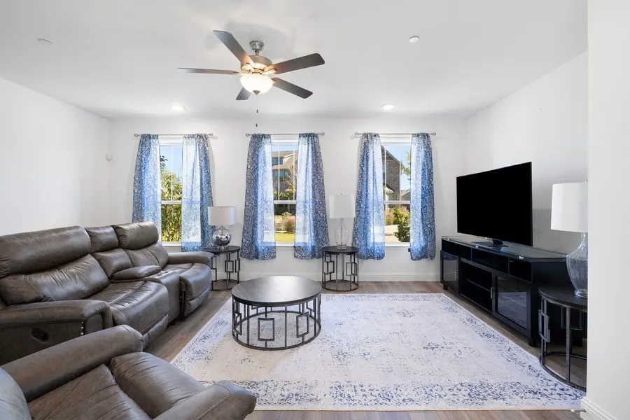 Living room with tall curtained windows at 4335 Fall Blossom Dr