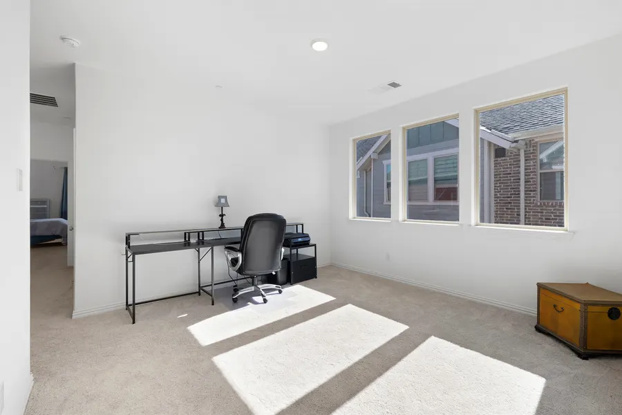 Primary bedroom with a silver dresser and teal curtains at 4335 Fall Blossom Dr