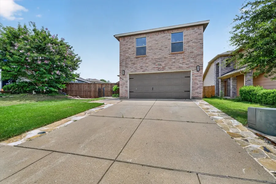 Wide concrete driveway leading to the two car garage at 716 River Hill Ln