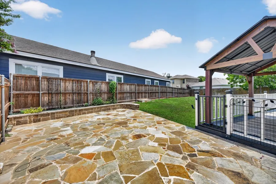 Flagstone patio and wood privacy fence in the backyard at 716 River Hill Ln